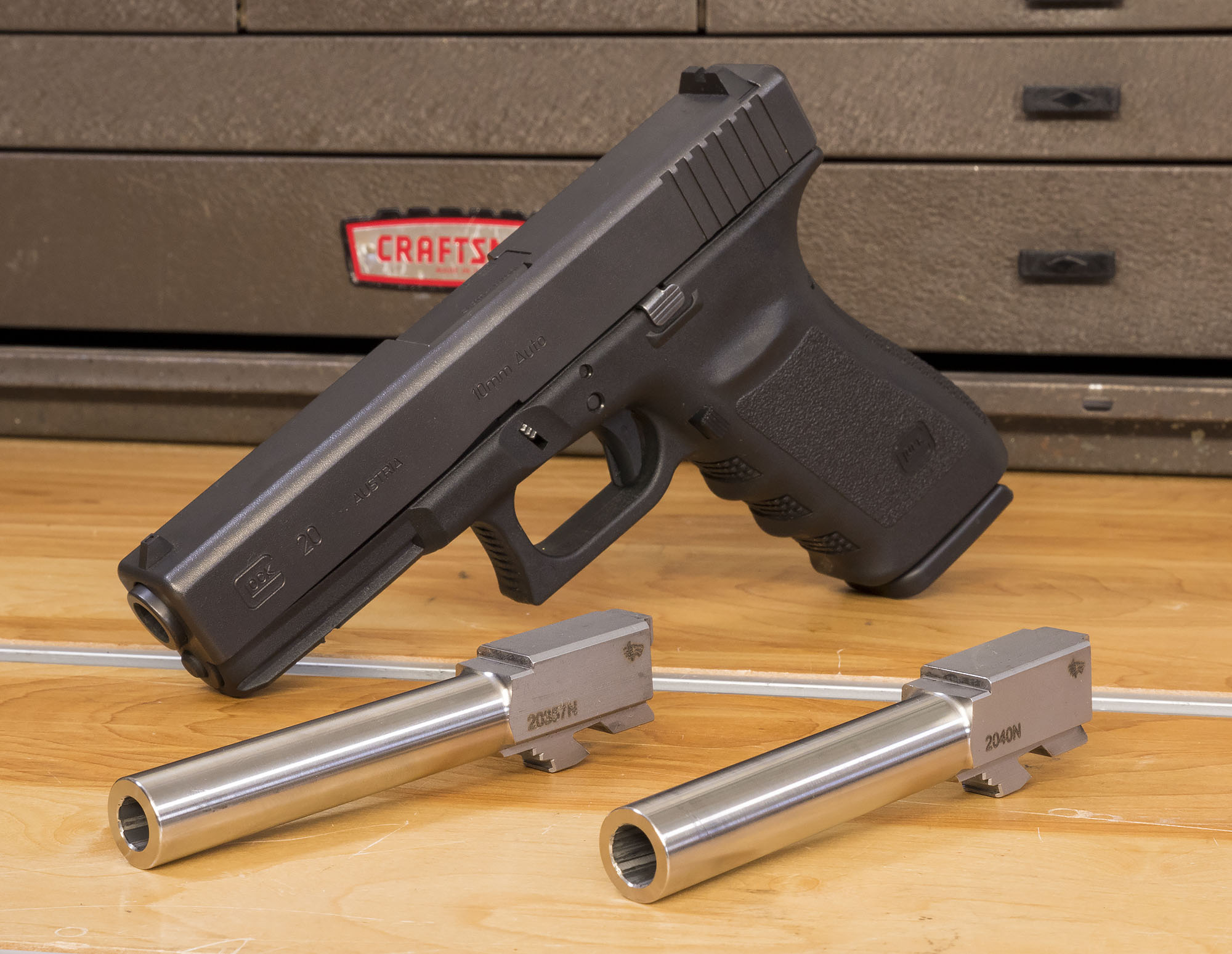 Above you see my Glock 20SF with 10mm Auto factory barrel, the. foreground,...